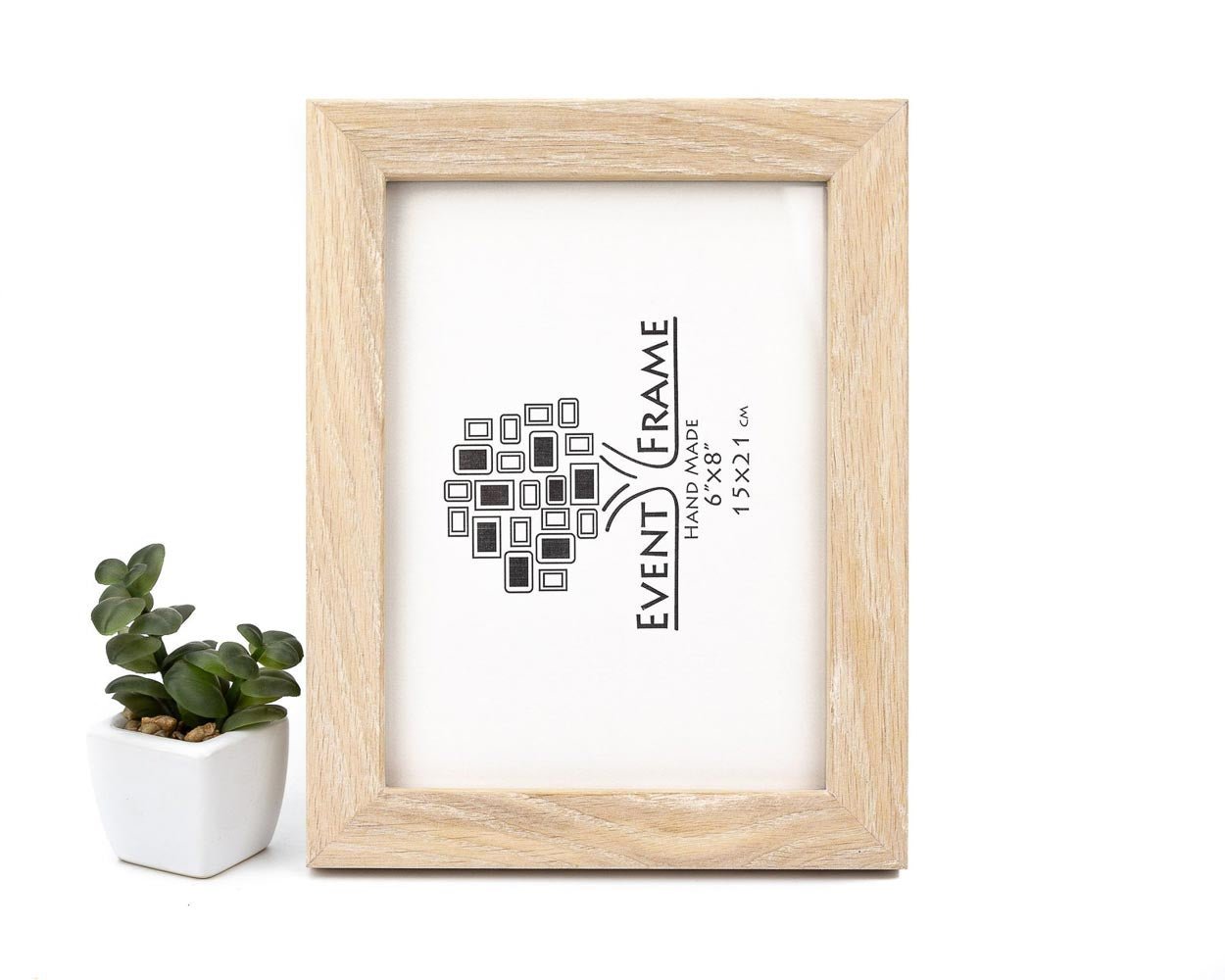 A bleached modern design solid oak hardwood photo frame with a white matte border and the brand 'EventFrame' printed on the front, displayed next to a small potted plant. Bleached Oak Wooden Photo Frame, White Farmhouse Picture Frame, Photo Frame for Wall Art 5x7, A1, 8x10, 11x14, 12x16, 12x18, 16x20, 18x24